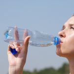hot-weather-woman-drinking-water-out-of-bottle